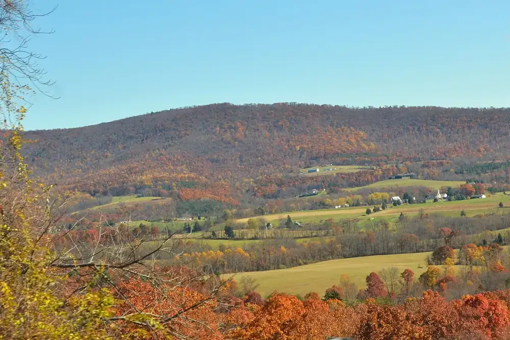Autumn-colored hills and farm fields in a valley in Murrysville, Pennsylvania