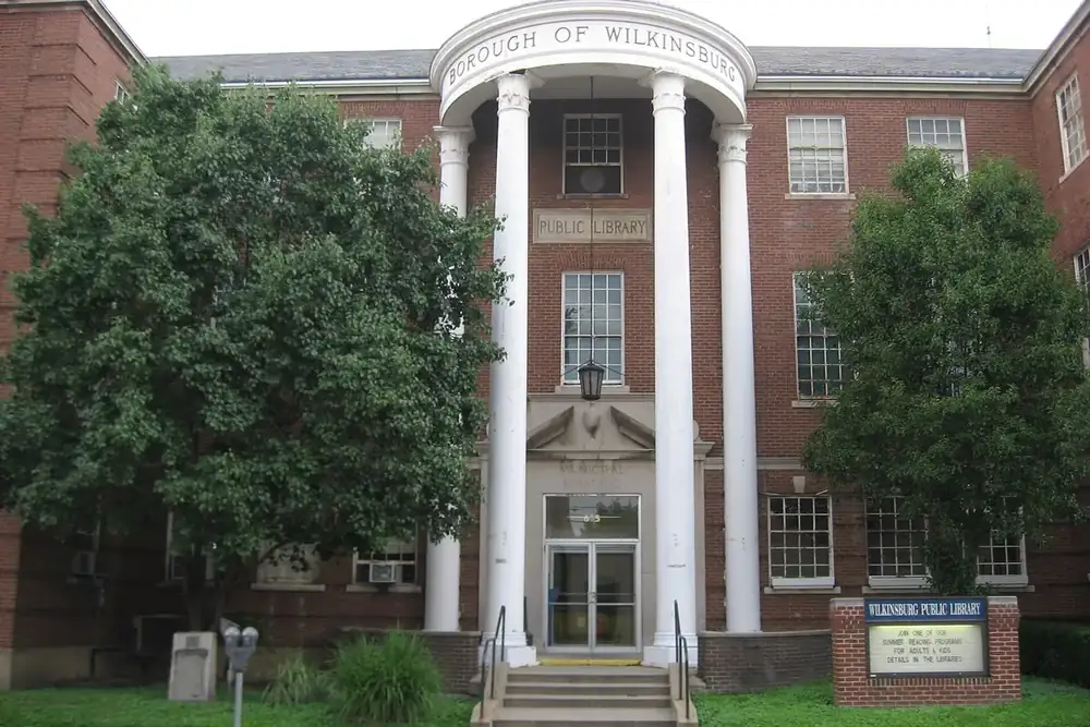 Brick municipal building and public library with tall white columns in Wilkinsburg, Pennsylvania